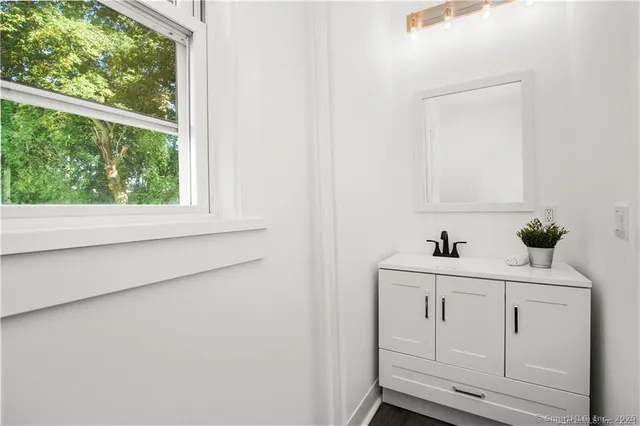 a kitchen with stainless steel appliances white cabinets and a stove top oven