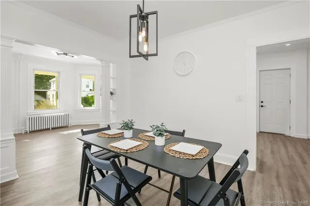 a view of a dining room with furniture window and wooden floor