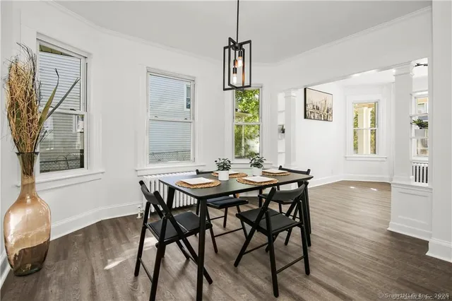 a view of a dining room with furniture window and wooden floor