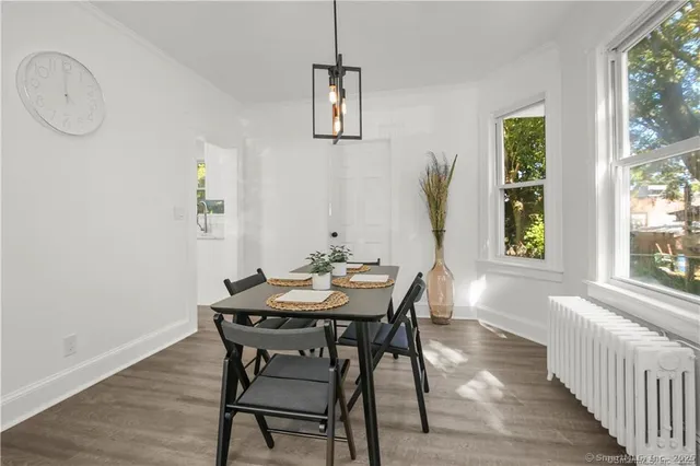 a view of a dining room with furniture and wooden floor