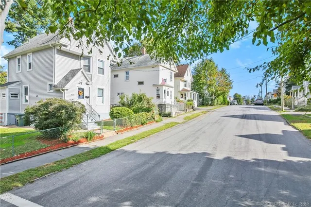 a front view of a house with a yard and a garage