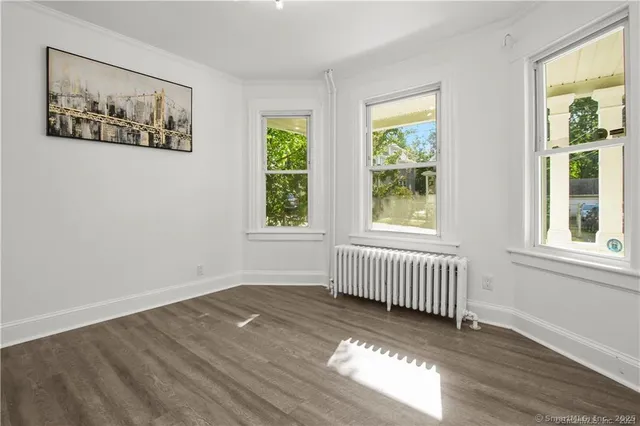 a view of a livingroom with furniture and a floor to ceiling window