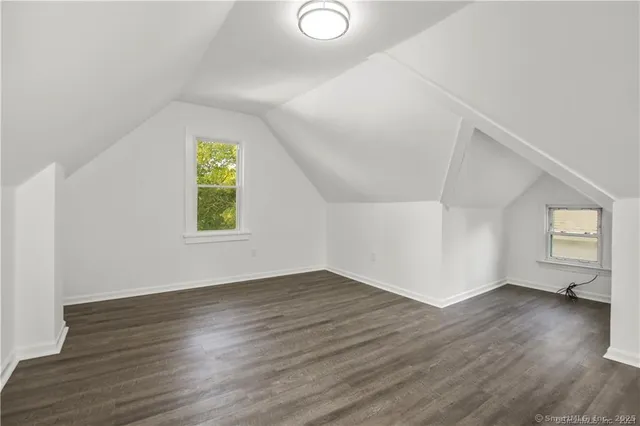 a view of a hallway with wooden floor and stairs