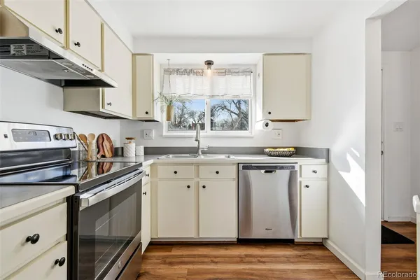 a kitchen with stainless steel appliances granite countertop a sink and a stove