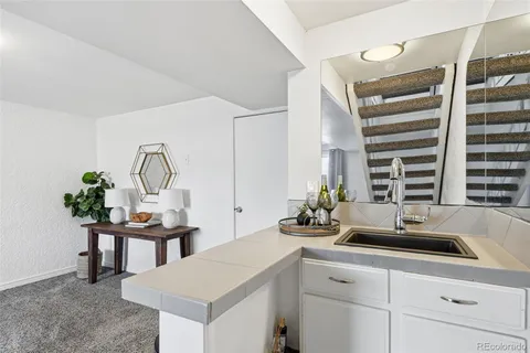 a kitchen with a sink cabinets and a window