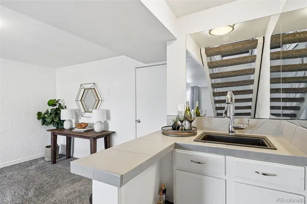 a kitchen with a sink cabinets and a window