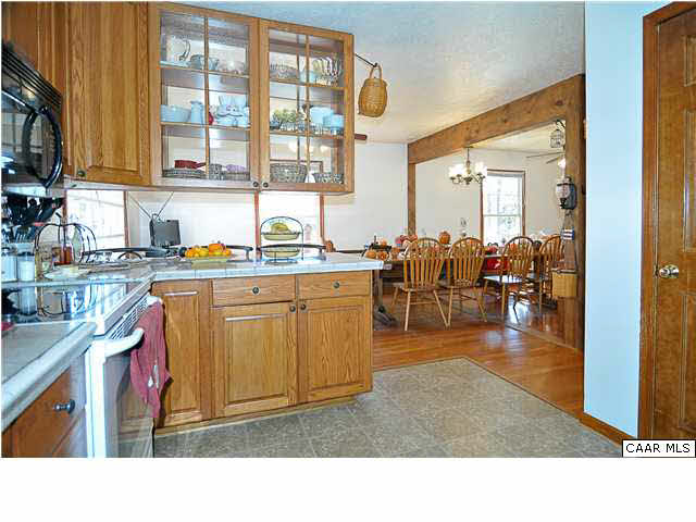 9057 Poindexter Road Louisa, VA 23093 - Photo 12 of 35 a kitchen filled with stainless steel appliances granite countertop a sink dishwasher stove and cabinets