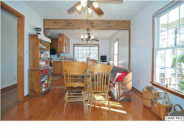 9057 Poindexter Road Louisa, VA 23093 - Photo 4 of 35 a living room with stainless steel appliances kitchen island granite countertop a dining table chairs and a large window