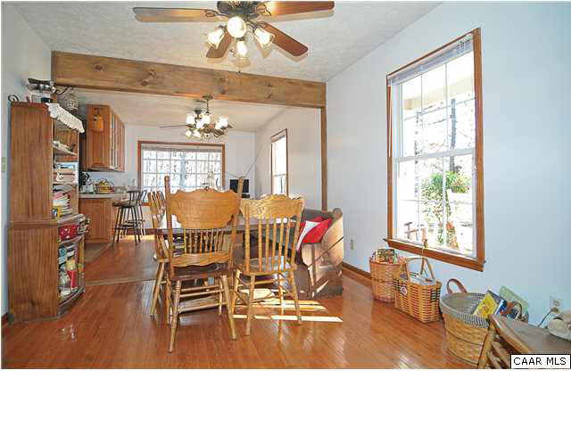 9057 Poindexter Road Louisa, VA 23093 - Photo 5 of 35 a living room with furniture a chandelier and a dining table