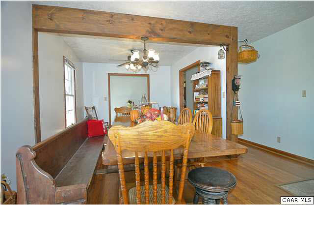 9057 Poindexter Road Louisa, VA 23093 - Photo 6 of 35 a living room with furniture and a chandelier