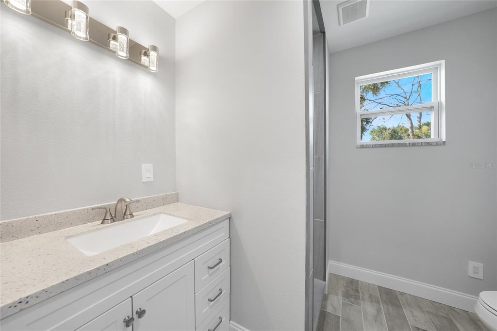 1450 New Point Comfort Road Englewood, FL 34223 - Photo 14 of 50 a bathroom with a sink and a mirror