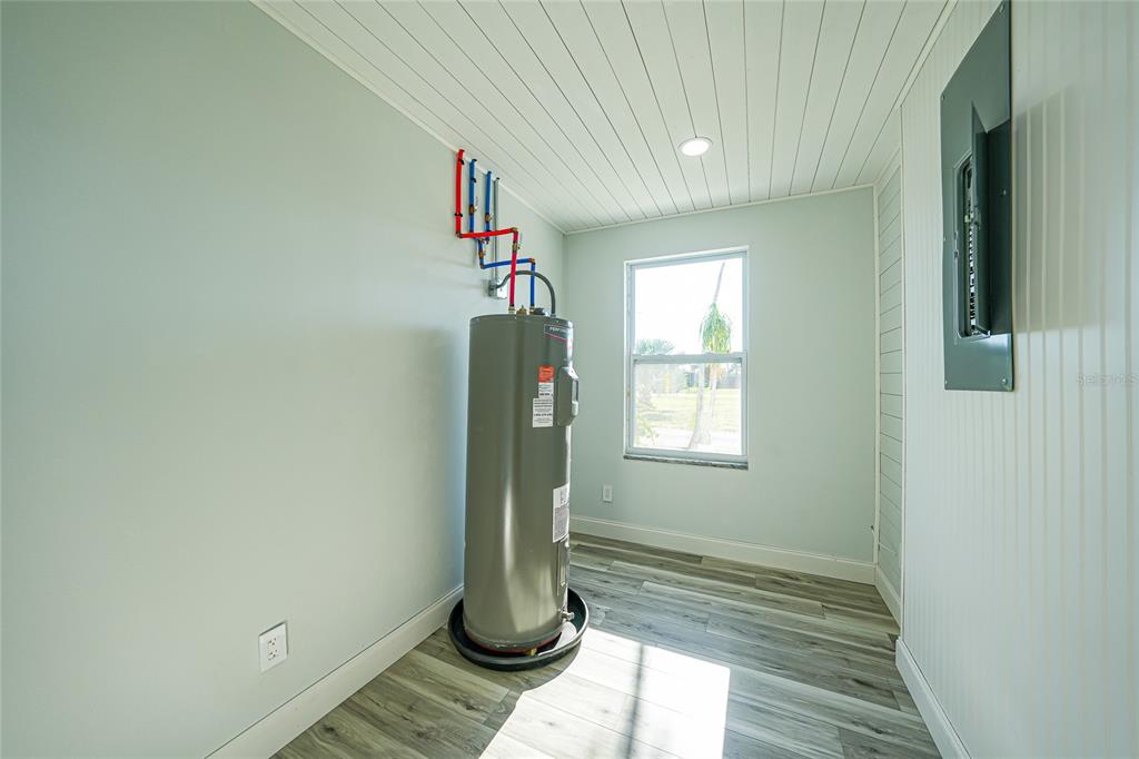 1450 New Point Comfort Road Englewood, FL 34223 - Photo 18 of 50 an empty room with wooden floor and a window