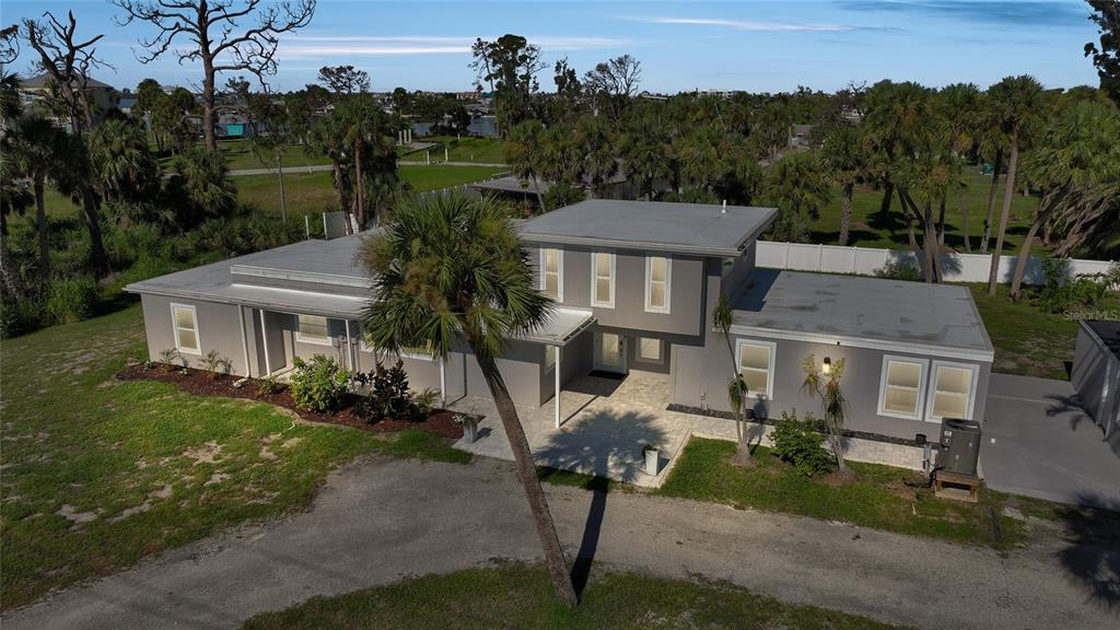 1450 New Point Comfort Road Englewood, FL 34223 - Photo 2 of 50 a front view of a house with garden