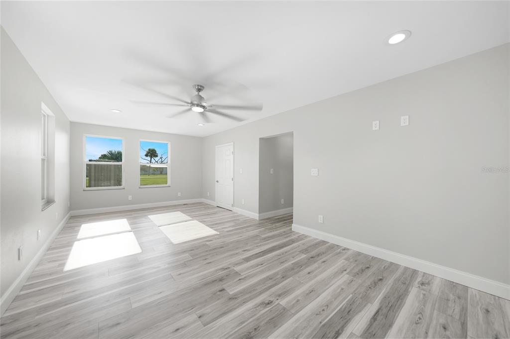 1450 New Point Comfort Road Englewood, FL 34223 - Photo 22 of 50 wooden floor in an empty room with a window