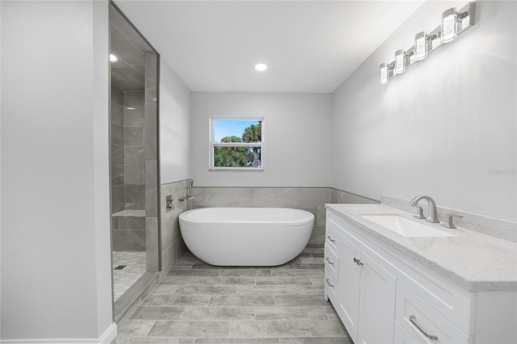 1450 New Point Comfort Road Englewood, FL 34223 - Photo 23 of 50 a bathroom with a sink and a mirror