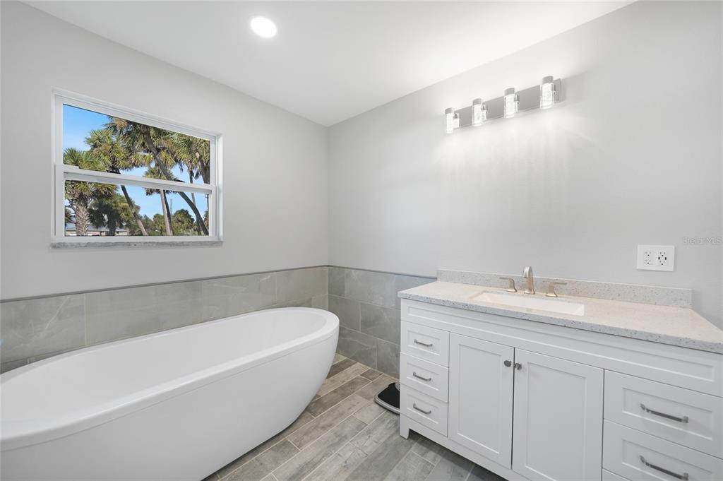 1450 New Point Comfort Road Englewood, FL 34223 - Photo 24 of 50 a bathroom with a bathtub and a sink