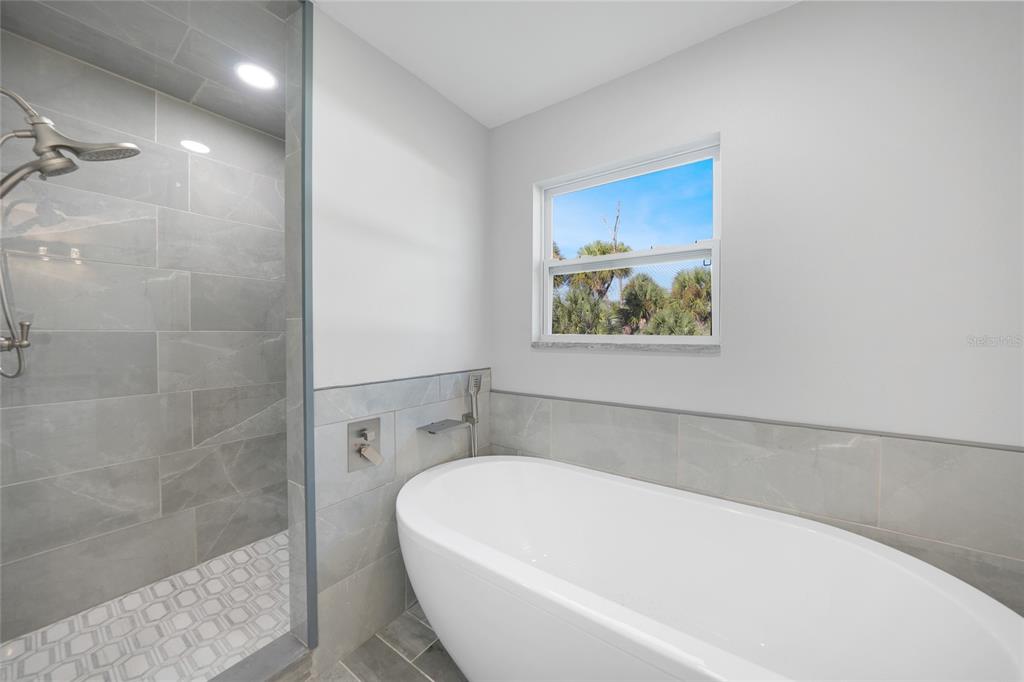 1450 New Point Comfort Road Englewood, FL 34223 - Photo 25 of 50 a bathroom with a bathtub and shower