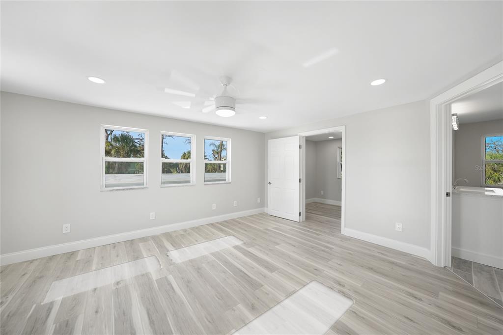 1450 New Point Comfort Road Englewood, FL 34223 - Photo 26 of 50 an empty room with wooden floor and windows