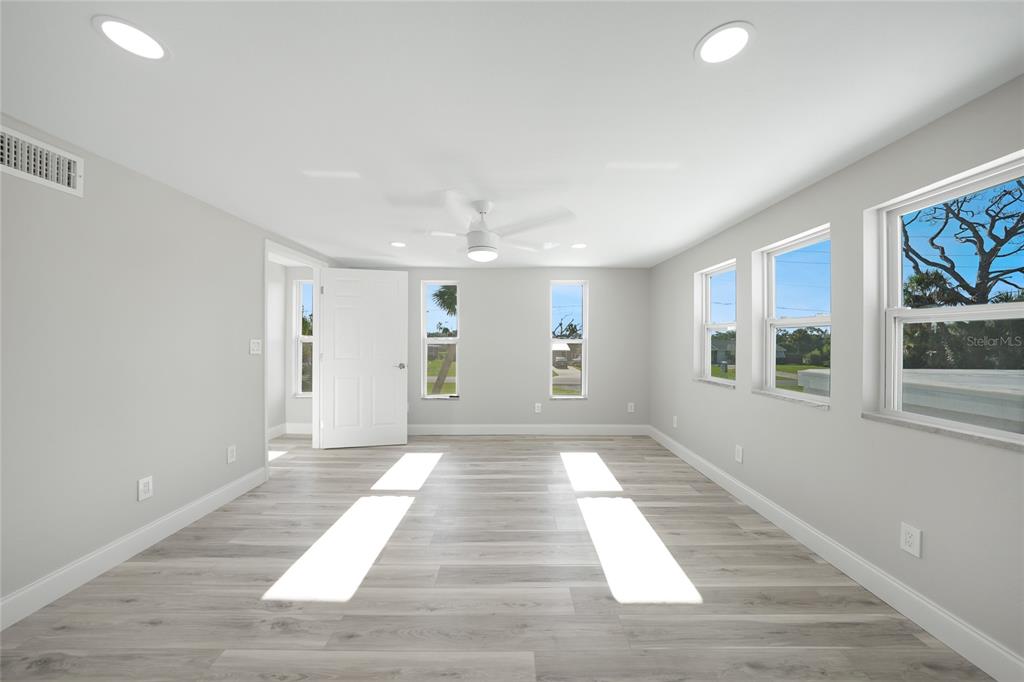 1450 New Point Comfort Road Englewood, FL 34223 - Photo 27 of 50 a view of an empty room with wooden floor and a window