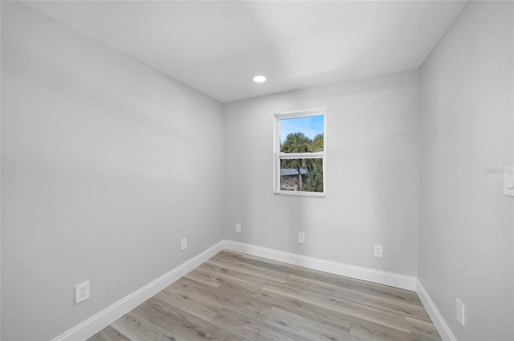 1450 New Point Comfort Road Englewood, FL 34223 - Photo 28 of 50 a view of empty room with wooden floor and fan