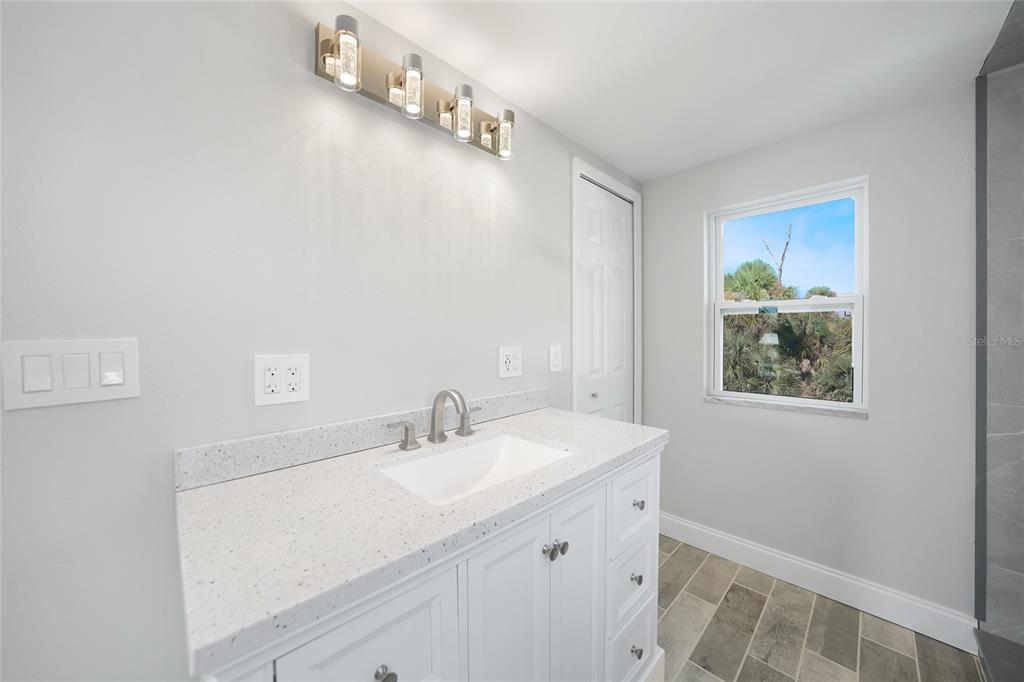 1450 New Point Comfort Road Englewood, FL 34223 - Photo 30 of 50 a bathroom with a sink a vanity and a mirror
