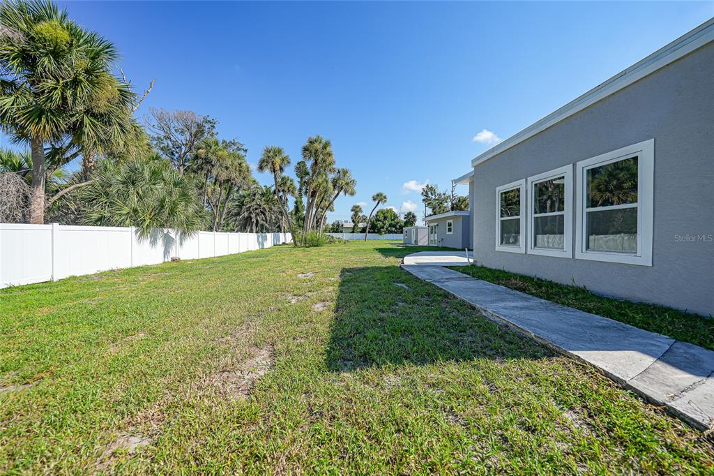 1450 New Point Comfort Road Englewood, FL 34223 - Photo 31 of 50 a view of a house with backyard and garden