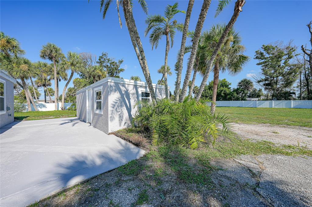 1450 New Point Comfort Road Englewood, FL 34223 - Photo 38 of 50 a view of a yard with palm tree