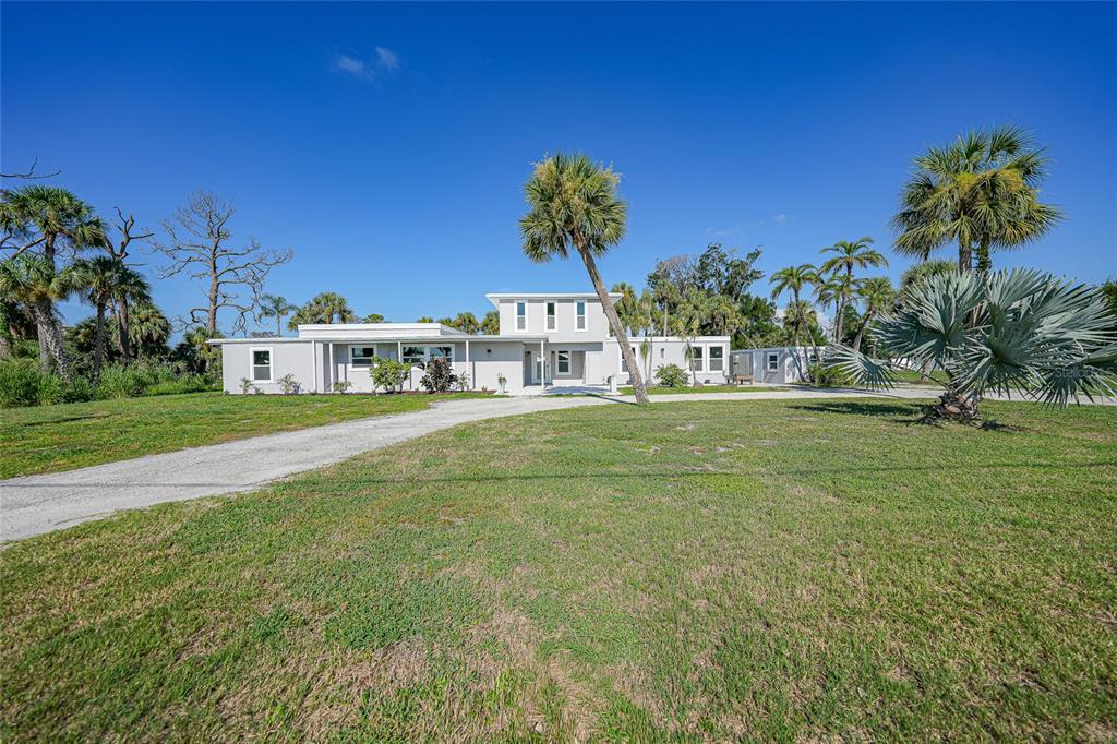 1450 New Point Comfort Road Englewood, FL 34223 - Photo 40 of 50 a house with garden in front of it