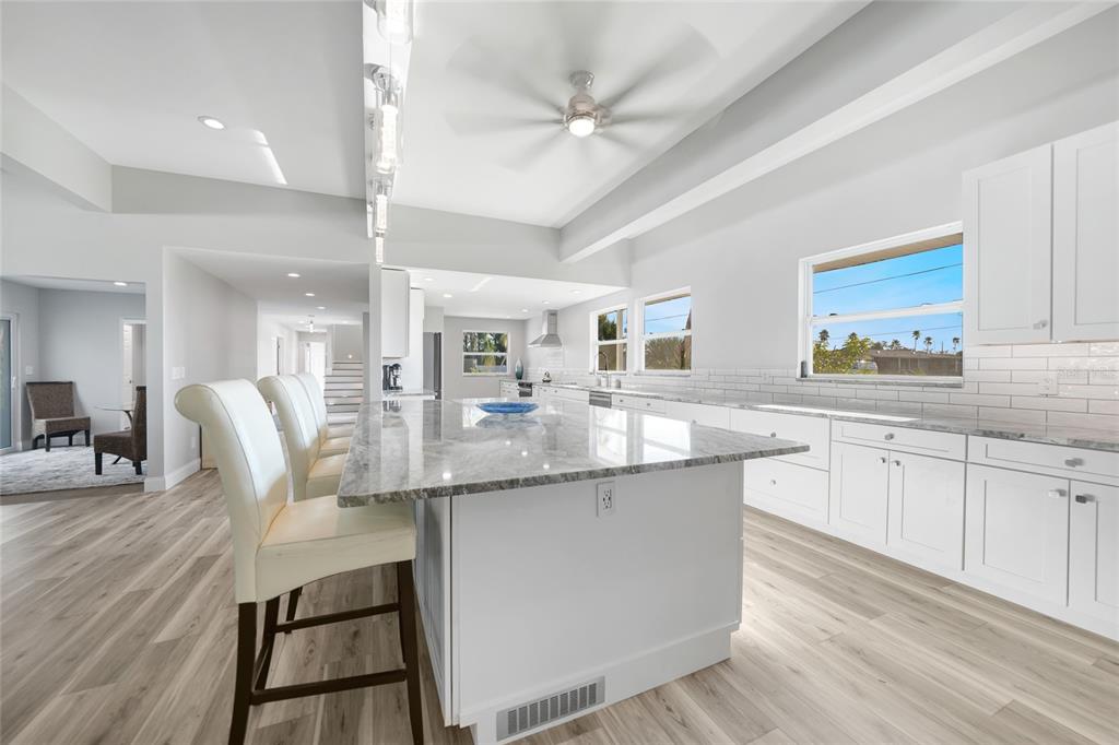 1450 New Point Comfort Road Englewood, FL 34223 - Photo 7 of 50 a kitchen with granite countertop cabinets a dining table and chairs