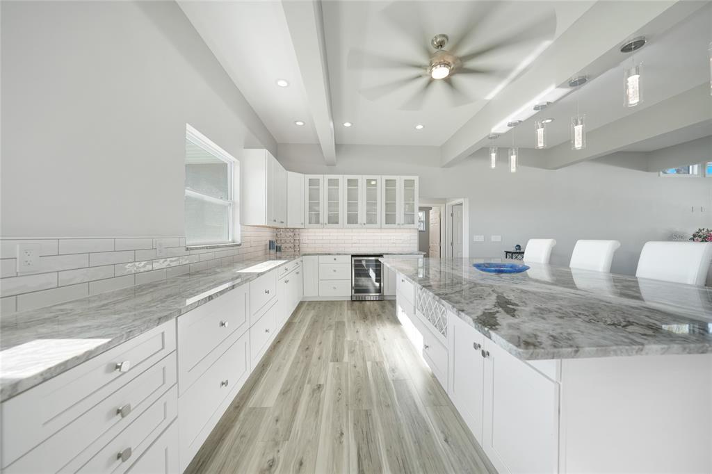 1450 New Point Comfort Road Englewood, FL 34223 - Photo 8 of 50 a large kitchen with kitchen island a large counter space a sink appliances and cabinets