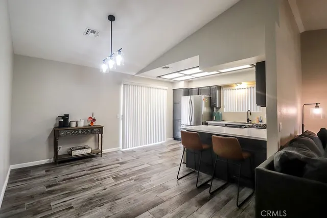 a view of a room with furniture and a chandelier
