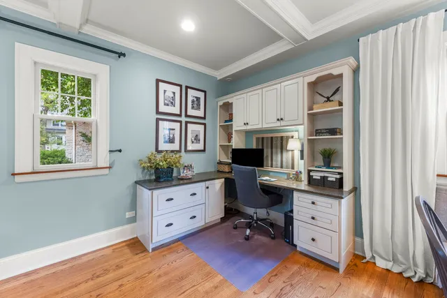 a view of a workspace with furniture and a window