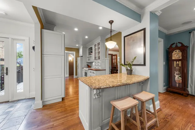 a kitchen with granite countertop kitchen island a sink appliances and a counter