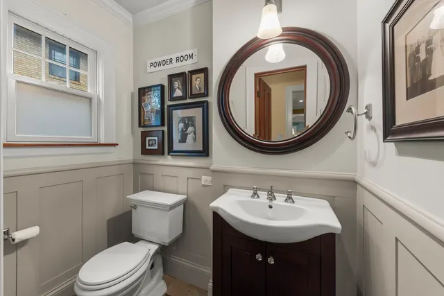 a bathroom with a toilet a sink and a mirror
