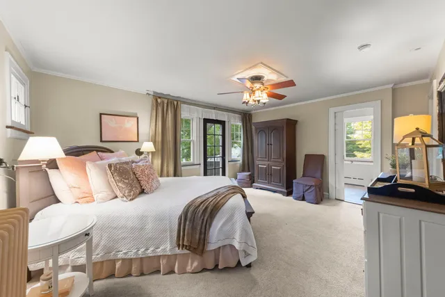 a bedroom with a large bed and a chandelier