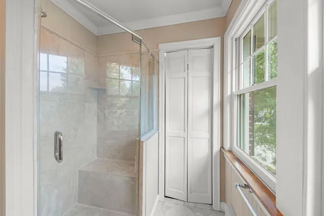 a bathroom with a shower and a glass door
