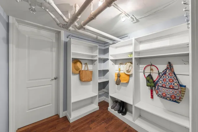 a hallway with painting on the wall and a window