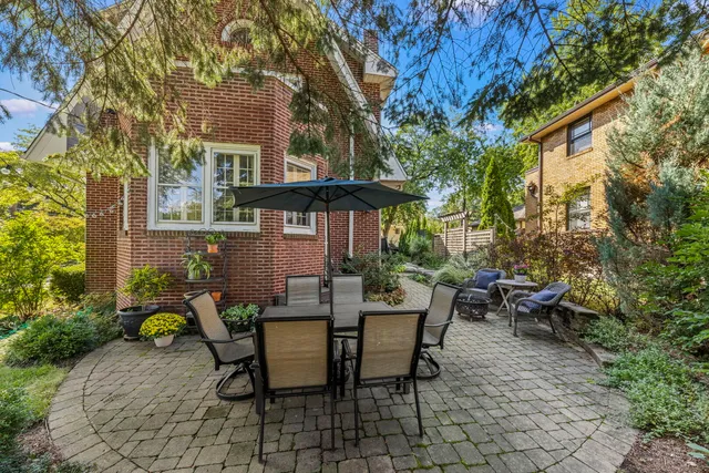 a view of a patio with table and chairs and potted plants