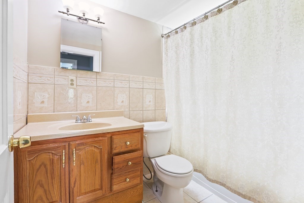 3 Overlook Road Needham, MA 02492 - Photo 26 of 32 a bathroom with a sink a toilet and mirror