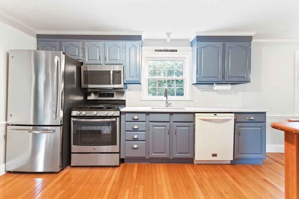3 Overlook Road Needham, MA 02492 - Photo 7 of 32 a kitchen with stainless steel appliances granite countertop a refrigerator microwave and sink