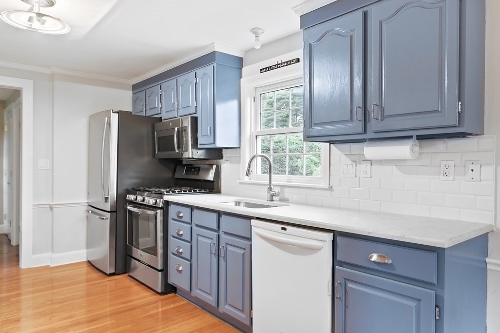 3 Overlook Road Needham, MA 02492 - Photo 8 of 32 a kitchen with stainless steel appliances granite countertop a sink stove and refrigerator