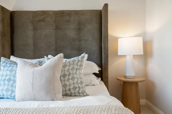 a bedroom with furniture and wooden floor