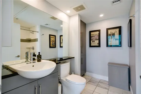 a bathroom with a toilet a sink and mirror