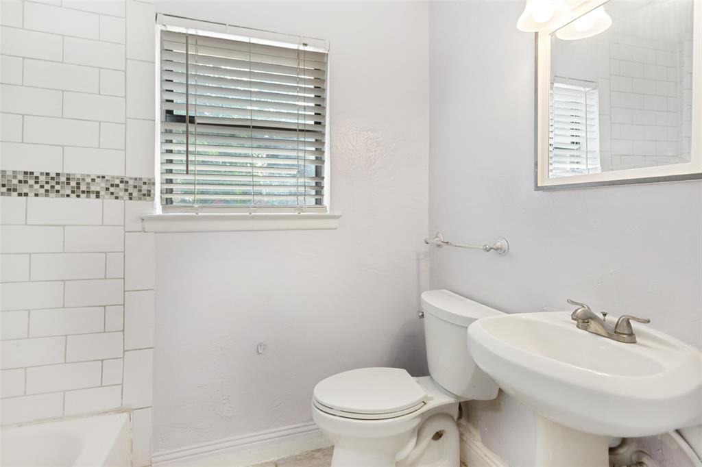 1904 Old Kirk Road Bedford, TX 76022 - Photo 17 of 25 a bathroom with a sink a toilet and a mirror
