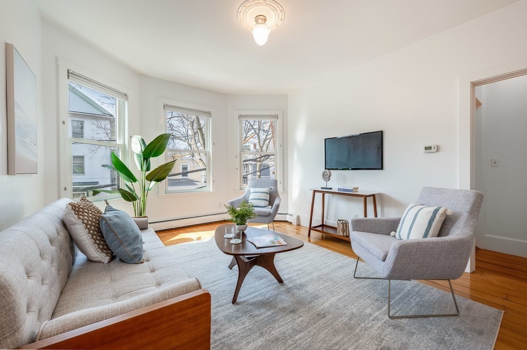 44 Roberts Road, Unit 2 Cambridge, MA 02138 - Photo 1 of 36 a living room with furniture a flat screen tv and a potted plant