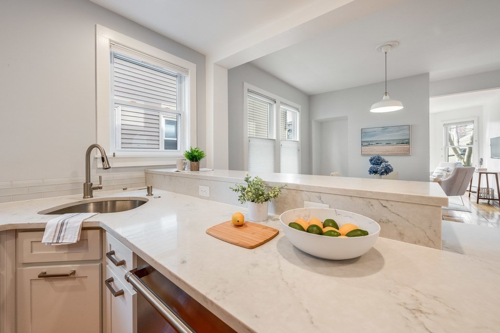 44 Roberts Road, Unit 2 Cambridge, MA 02138 - Photo 13 of 36 a kitchen with a sink a stove and chairs