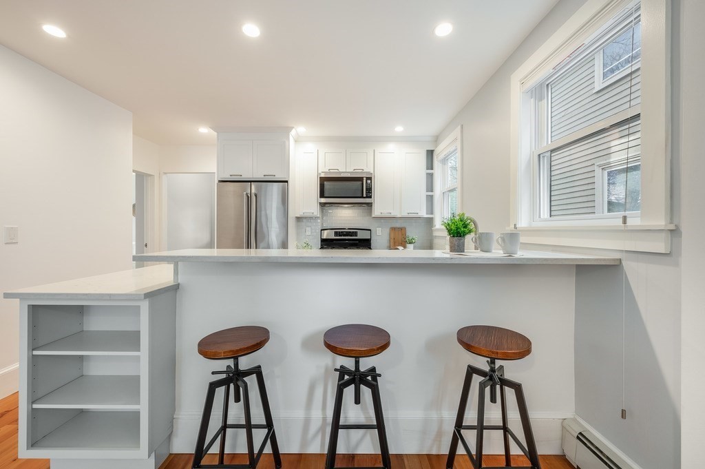 44 Roberts Road, Unit 2 Cambridge, MA 02138 - Photo 10 of 36 a kitchen with stainless steel appliances a table and chairs in it