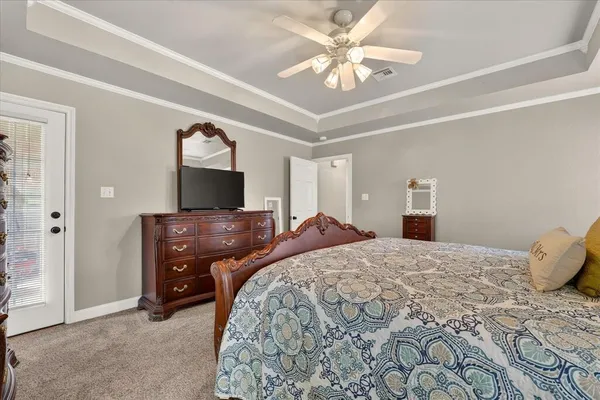 a bedroom with a bed and a chandelier
