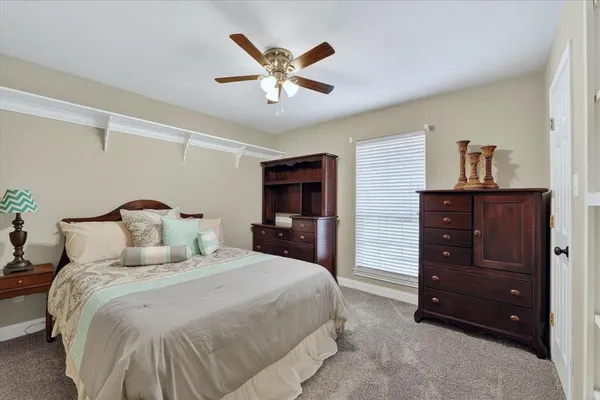 a bedroom with a bed and a dresser