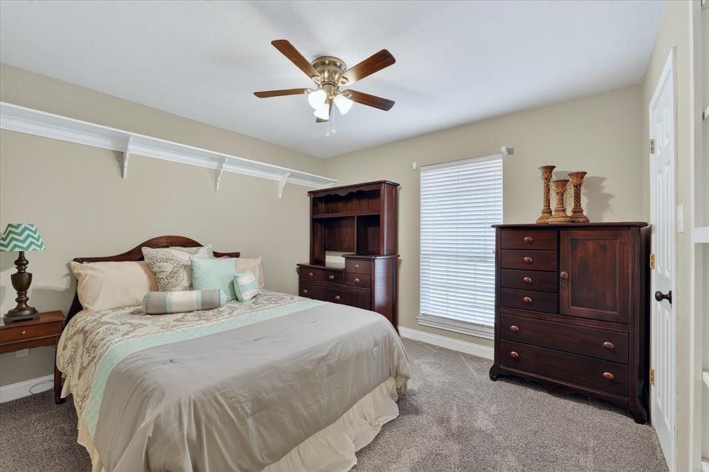 703 Gibraltar Lane Lorena, TX 76655 - Photo 14 of 39 a bedroom with a bed and a dresser